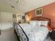 Warm bedroom featuring neutral walls, a large window, and a comfortable wrought iron bed at 18930 Wood Sage Dr, Tampa, FL 33647