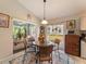 Bright breakfast nook with glass-top table and chairs adjacent to the kitchen, offering views of the backyard at 18930 Wood Sage Dr, Tampa, FL 33647