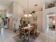 Bright dining room featuring tile floors, decorative chandelier and view to the Gathering room at 18930 Wood Sage Dr, Tampa, FL 33647