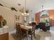 Bright dining room featuring tile floors, decorative chandelier and view to the Gathering room at 18930 Wood Sage Dr, Tampa, FL 33647