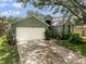 Charming single-Gathering home featuring a well-manicured lawn and inviting front entrance with mature shade trees at 18930 Wood Sage Dr, Tampa, FL 33647