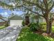 Charming single-Gathering home featuring a well-manicured lawn and inviting front entrance with mature shade trees at 18930 Wood Sage Dr, Tampa, FL 33647