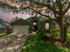 Charming single-Gathering home featuring a well-manicured lawn and inviting front entrance with mature shade trees at 18930 Wood Sage Dr, Tampa, FL 33647