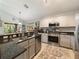 Traditional kitchen with stainless appliances, granite countertops, and a view to the backyard at 18930 Wood Sage Dr, Tampa, FL 33647