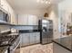 Updated kitchen features stainless steel appliances, white cabinets, and dark granite counters at 18930 Wood Sage Dr, Tampa, FL 33647