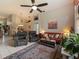 Bright living room features neutral walls, tile floors, ceiling fan, and comfortable furnishings at 18930 Wood Sage Dr, Tampa, FL 33647