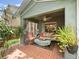 Relaxing screened porch with comfortable furniture, plants, and a ceiling fan at 18930 Wood Sage Dr, Tampa, FL 33647