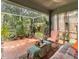 Cozy screened porch filled with plants and comfortable seating at 18930 Wood Sage Dr, Tampa, FL 33647