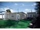 Quaint backyard features an additional building and a lush green artificial turf at 2108 W Comanche Ave, Tampa, FL 33603