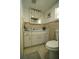 Cozy bathroom featuring ceramic tiled walls, toilet, vanity and mirrored medicine cabinet at 2108 W Comanche Ave, Tampa, FL 33603