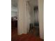 Bright bathroom entrance featuring tiled floors and a shower with stylish curtain and fixtures at 2108 W Comanche Ave, Tampa, FL 33603