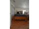 Bedroom with laminate floors featuring a cozy bed adorned with teddy bears and ample natural light at 2108 W Comanche Ave, Tampa, FL 33603