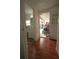 Hallway leading to bathroom, and a covered exterior space, all featuring laminate flooring at 2108 W Comanche Ave, Tampa, FL 33603