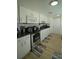 Bright kitchen featuring modern appliances, white cabinetry, and stylish backsplash at 2108 W Comanche Ave, Tampa, FL 33603