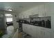 Bright kitchen with white cabinets, modern appliances, and a dining area at 2108 W Comanche Ave, Tampa, FL 33603
