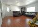Bright living room featuring laminate floors, comfortable seating, and an inviting atmosphere at 2108 W Comanche Ave, Tampa, FL 33603