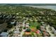 Aerial view shows home in community with lake, mature trees and lush landscaping at 2406 Dana Dr, Safety Harbor, FL 34695