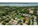 Aerial view showing home, lake with fountain, community, and bay in distance at 2406 Dana Dr, Safety Harbor, FL 34695