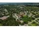 Overhead view of home, pond with fountain, and neighborhood in a lush setting at 2406 Dana Dr, Safety Harbor, FL 34695