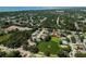 Aerial view showing home and community with lush landscaping including a lake at 2406 Dana Dr, Safety Harbor, FL 34695