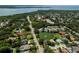 Aerial view of the community featuring lush tree coverage and a large pond at 2406 Dana Dr, Safety Harbor, FL 34695