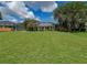 Expansive backyard with lush lawn, screened-in porch and mature landscaping at 2406 Dana Dr, Safety Harbor, FL 34695