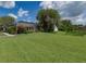 Expansive backyard with a screened-in pool area and plenty of green space at 2406 Dana Dr, Safety Harbor, FL 34695