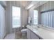 Bathroom featuring a vanity, toilet, and window with privacy blinds at 2406 Dana Dr, Safety Harbor, FL 34695