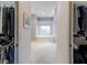 Walk in closet view to ensuite bath featuring a large soaking tub below a window at 2406 Dana Dr, Safety Harbor, FL 34695