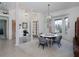 Airy dining area with large windows, white walls, decorative chandelier, and view to entry at 2406 Dana Dr, Safety Harbor, FL 34695
