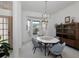A stylish dining area with a large bay window, a chandelier, and a view to other rooms at 2406 Dana Dr, Safety Harbor, FL 34695