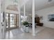 Bright foyer with tile flooring, decorative columns, and a view into the dining area at 2406 Dana Dr, Safety Harbor, FL 34695