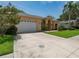 Well-maintained single-Gathering home with lush lawn, a two-car garage, and a charming entryway at 2406 Dana Dr, Safety Harbor, FL 34695