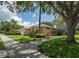 A cozy single-Gathering home with a well-manicured lawn, plants and a sidewalk at 2406 Dana Dr, Safety Harbor, FL 34695