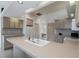 Open kitchen with bright countertops, tiled floors, and a large sink area at 2406 Dana Dr, Safety Harbor, FL 34695