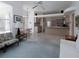 Bright living room featuring open-concept, large windows, and tiled kitchen access at 2406 Dana Dr, Safety Harbor, FL 34695