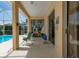 Covered patio featuring a poolside view and sliding glass doors leading into the home at 2406 Dana Dr, Safety Harbor, FL 34695