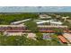 An aerial view displays lush landscaping, covered parking and various building styles in community at 2442 Enterprise Rd # 6, Clearwater, FL 33763
