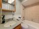 Well-maintained bathroom with tiled shower/tub, sink, and mirror, offering a clean and functional space at 2442 Enterprise Rd # 6, Clearwater, FL 33763