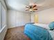 Well-lit bedroom with extensive closet space and a ceiling fan, maximizing comfort and convenience at 2442 Enterprise Rd # 6, Clearwater, FL 33763