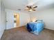 Inviting bedroom with a ceiling fan and a view into another room, creating an open and airy feel at 2442 Enterprise Rd # 6, Clearwater, FL 33763