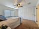 Bright bedroom with large closets, ceiling fan, and neutral carpet for a comfortable, personalized retreat at 2442 Enterprise Rd # 6, Clearwater, FL 33763