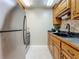 A functional kitchen featuring stainless steel appliances and wood cabinetry providing ample storage at 2442 Enterprise Rd # 6, Clearwater, FL 33763