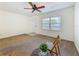 Living area with carpet, white walls, ceiling fan, and natural light from the window at 2442 Enterprise Rd # 6, Clearwater, FL 33763
