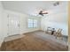 Living area with white walls, carpet, ceiling fan, and a front door and window view at 2442 Enterprise Rd # 6, Clearwater, FL 33763