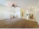 Bright living room with ceiling fan, carpet, neutral walls, and adjoining dining area at 2442 Enterprise Rd # 6, Clearwater, FL 33763