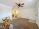 Open-concept living room featuring a ceiling fan, tile flooring, and neutral walls at 2442 Enterprise Rd # 6, Clearwater, FL 33763