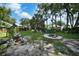 Relaxing backyard retreat with a fire pit, a swing, and plenty of space for outdoor entertaining at 2817 Rustic Oaks Dr, Palm Harbor, FL 34684