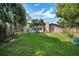Well-maintained backyard with a covered patio area for outdoor seating and relaxation at 2817 Rustic Oaks Dr, Palm Harbor, FL 34684