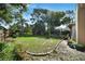 Spacious backyard featuring lush greenery, mature trees and room for outdoor activities at 2817 Rustic Oaks Dr, Palm Harbor, FL 34684